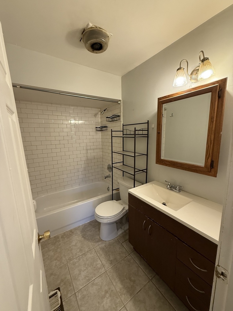 222 West Park Road Round Lake, IL 60073 - Photo 7 of 7 a bathroom with a sink a toilet and shower