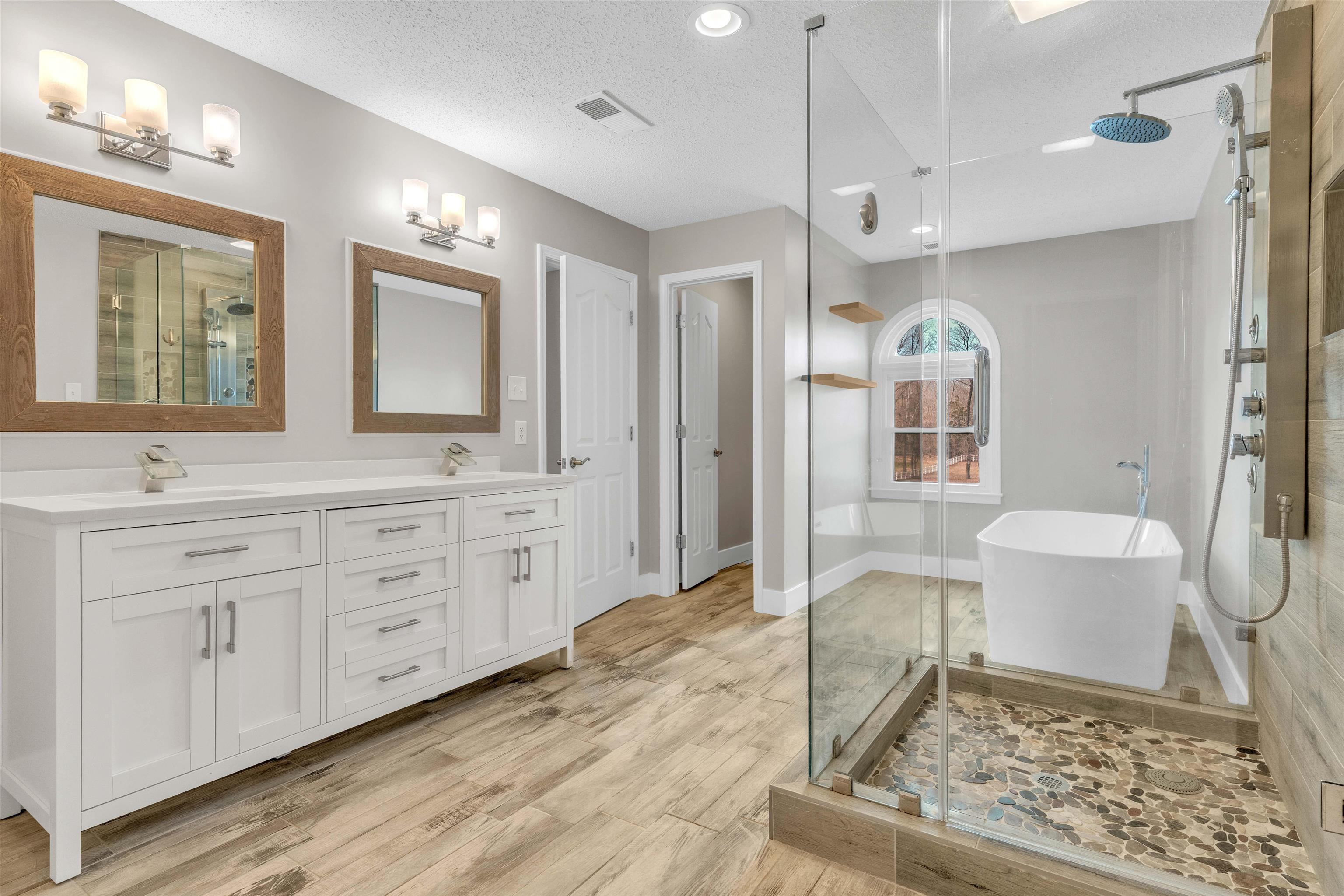 2470 North Reid Hooker Road Eads, TN 38028 - Photo 27 of 40 a spacious bathroom with a double vanity sink a mirror and a shower