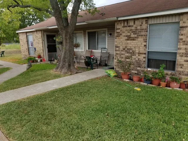 a front view of a house with a yard and porch