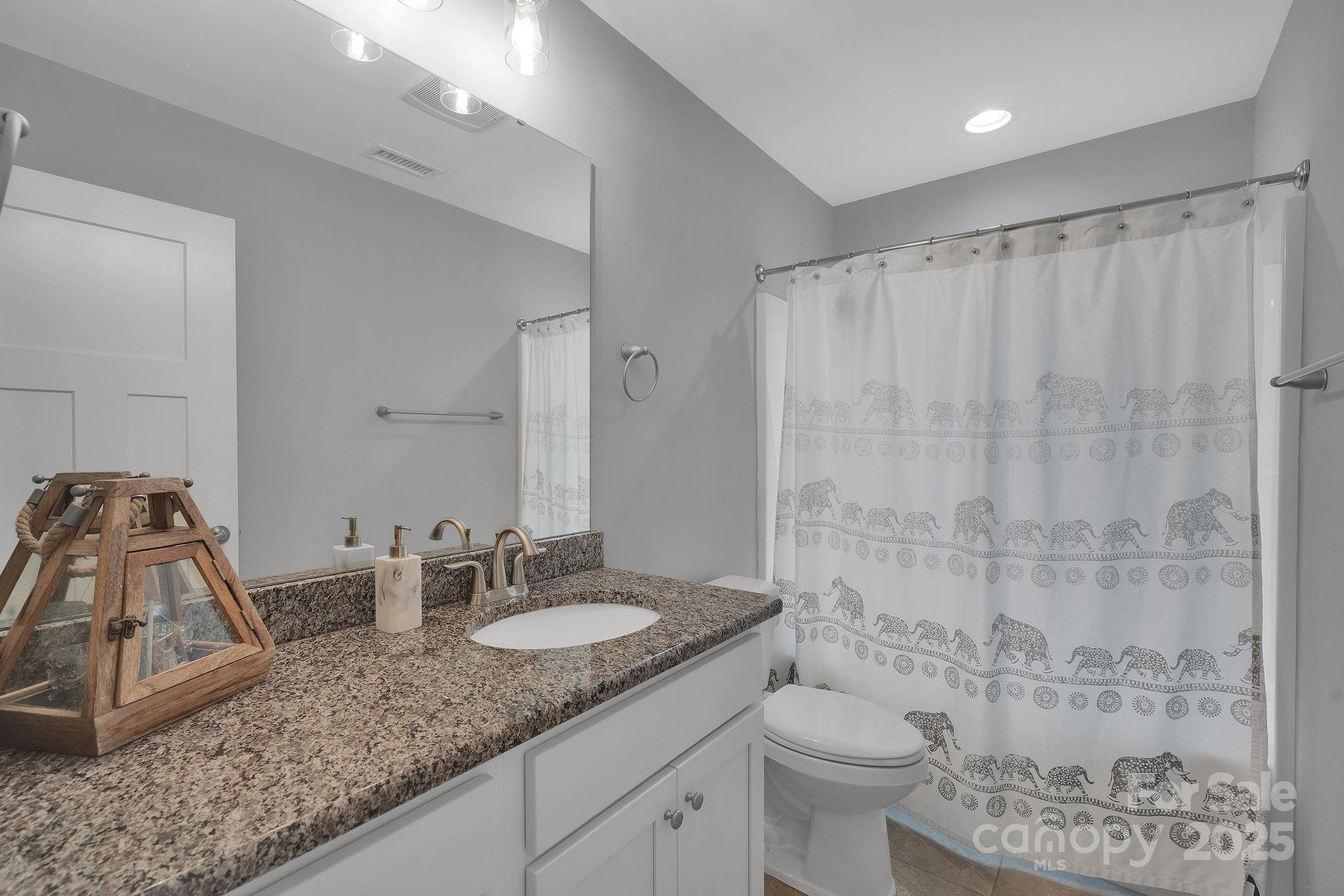 236 Pinnacle Crossing Shelby, NC 28152 - Photo 24 of 39 a bathroom with a granite countertop sink a toilet and a shower