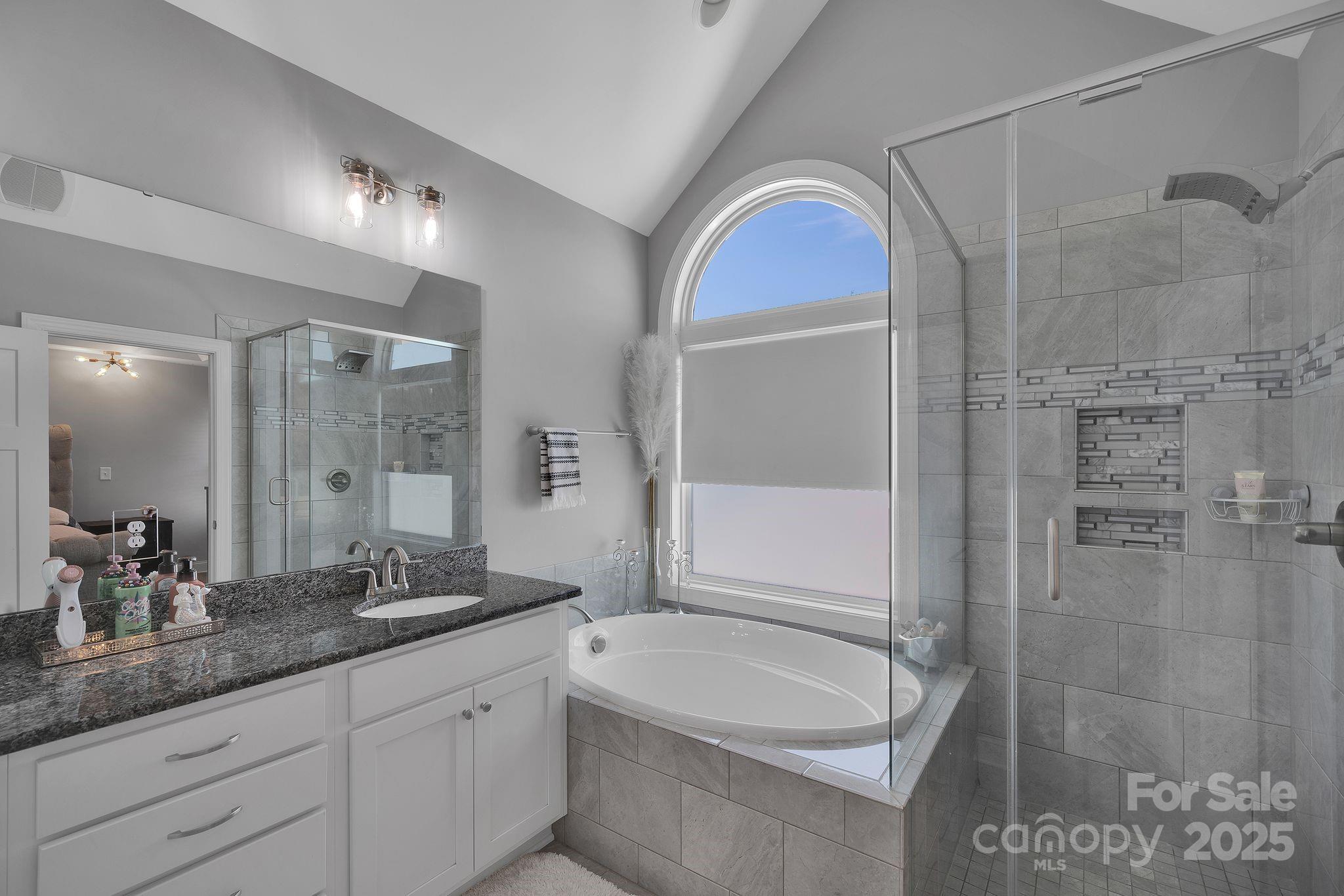 236 Pinnacle Crossing Shelby, NC 28152 - Photo 30 of 39 a bathroom with a granite countertop sink a mirror a bathtub and shower