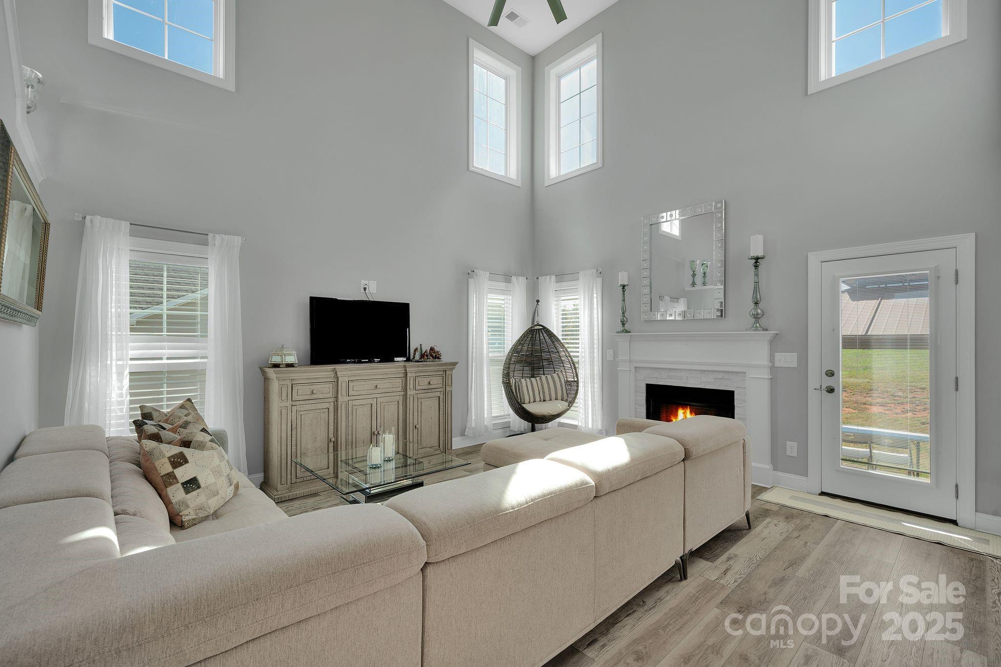 236 Pinnacle Crossing Shelby, NC 28152 - Photo 5 of 39 a living room with furniture a flat screen tv and a fireplace