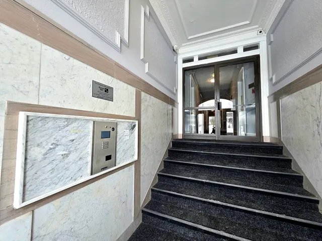a view of staircase with wooden floor and a large window