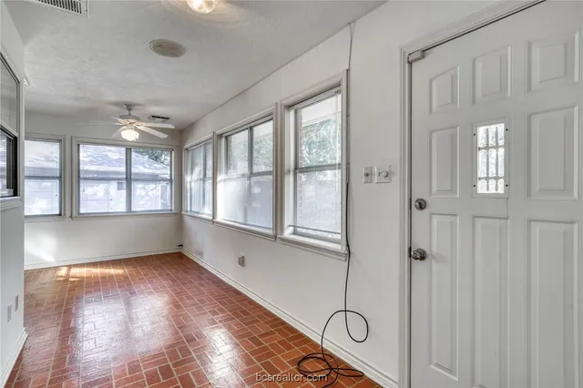 an empty room with windows and closet