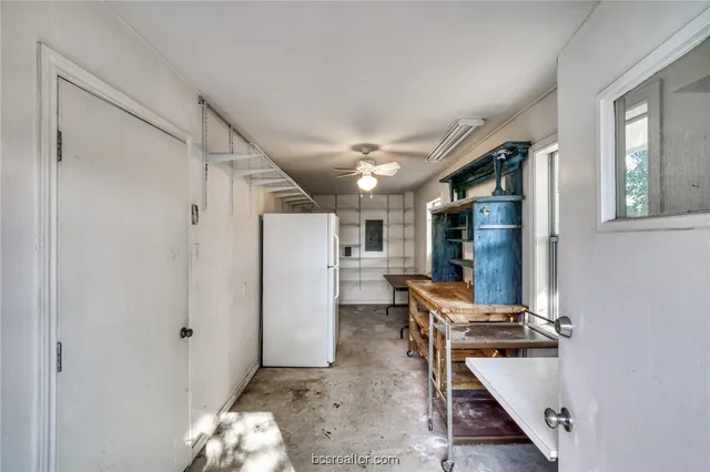 a view of a yard with plants and trees