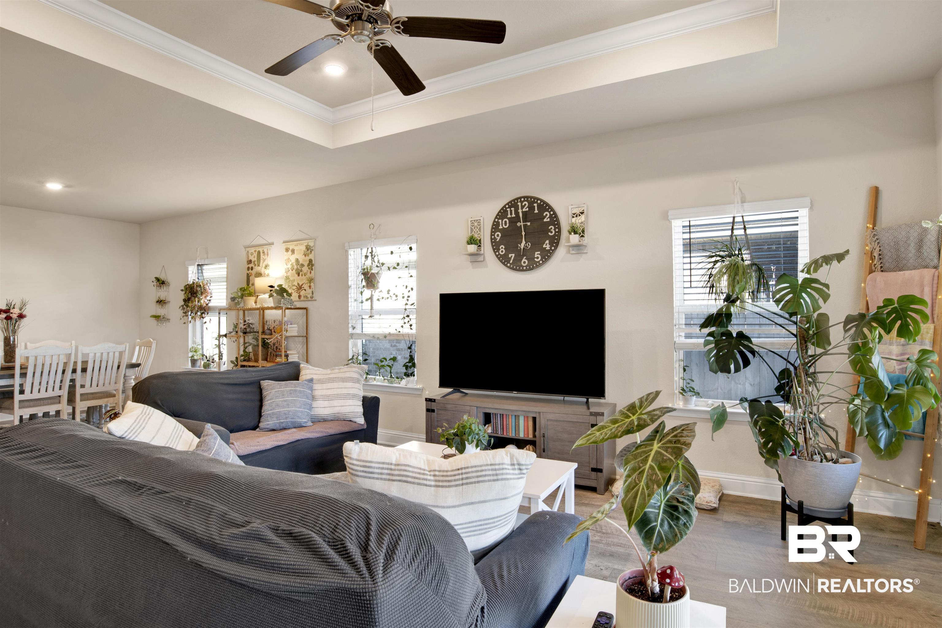 9622 Volterra Avenue Daphne, AL 36526 - Photo 13 of 31 Living room with a raised ceiling, ceiling fan, hardwood / wood-style floors, and ornamental molding