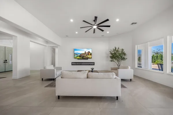 a living room with furniture and wooden floor