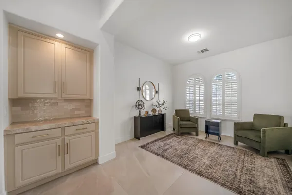 a bathroom with a granite countertop sink a toilet a mirror and shower