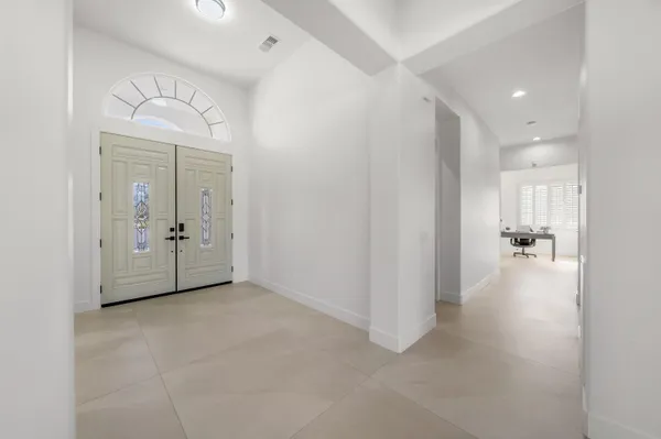 a bedroom with a bed and a large window