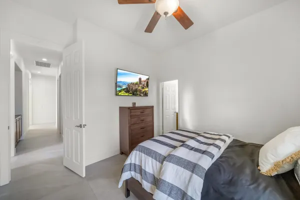 a bedroom with a bed and a painting on the wall