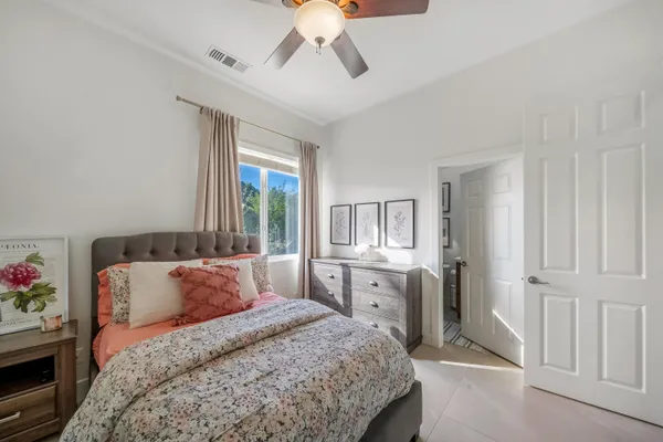 a spacious bedroom with a bed and large window