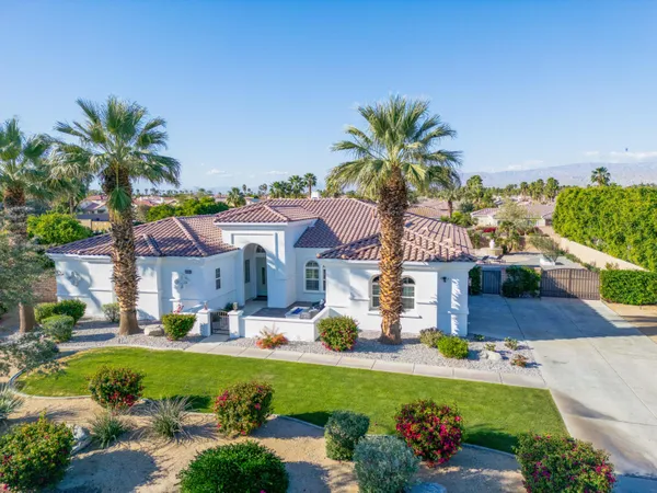 a front view of house with yard and outdoor seating