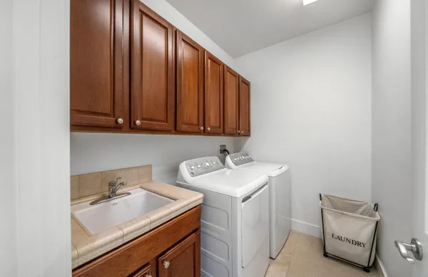 a living room with a couch and a potted plant