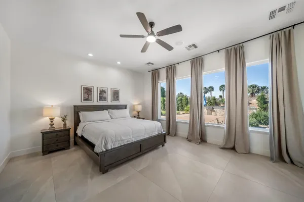 a living room with patio furniture and a floor to ceiling window