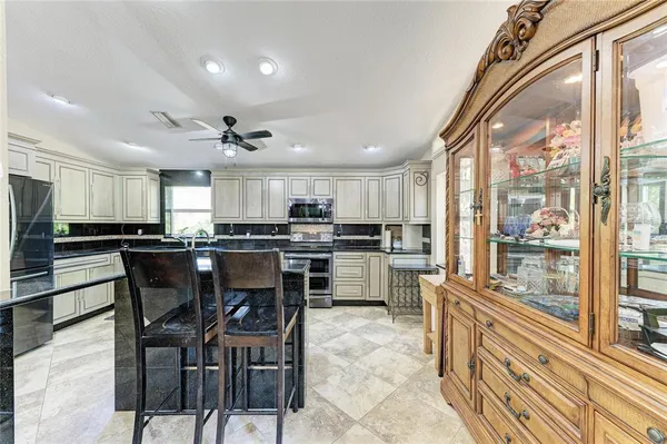 a room with pool table and windows