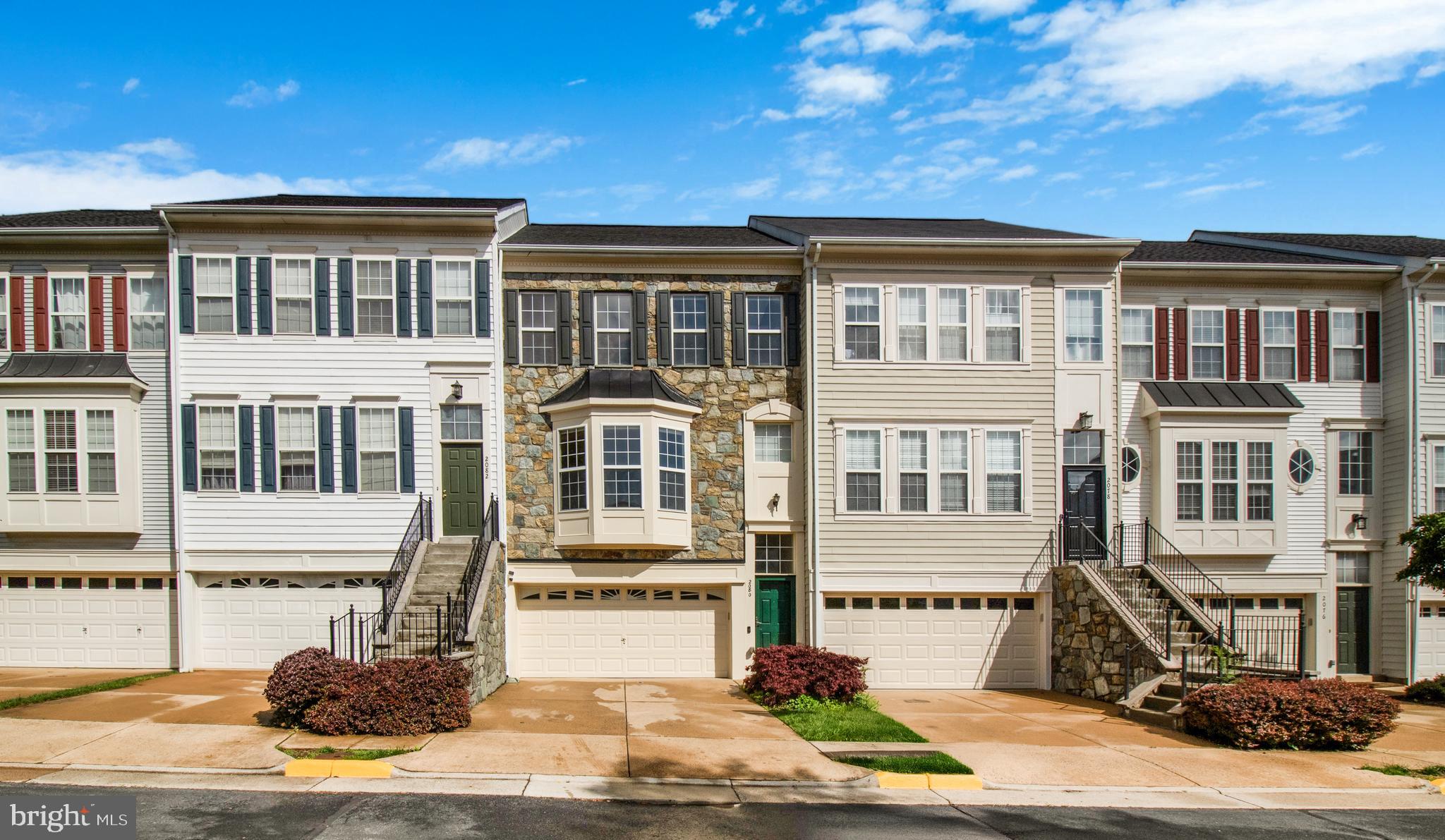 a front view of a residential apartment building with a yard