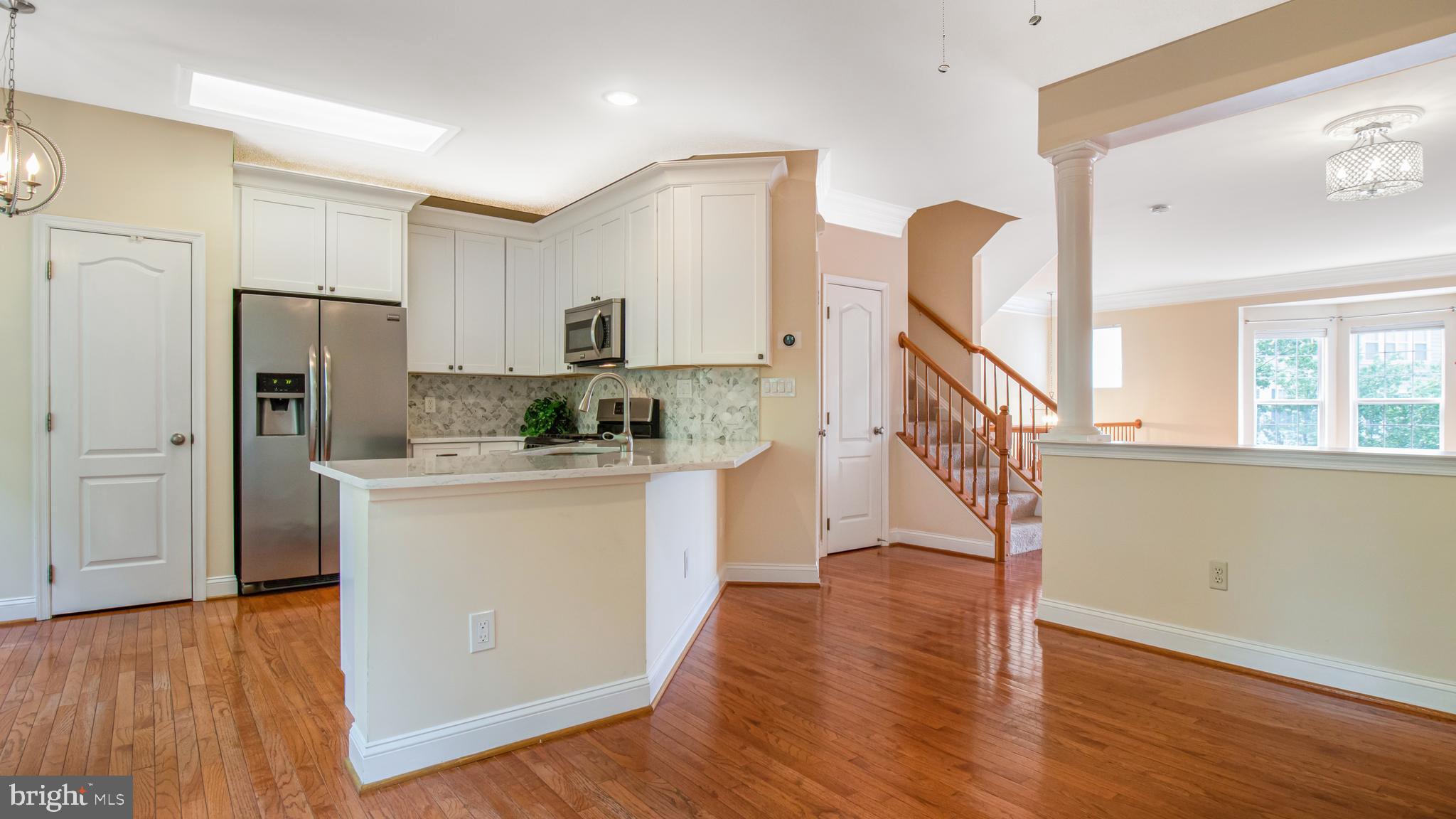 2080 Capstone Circle Herndon, VA 20170 - Photo 17 of 38 a kitchen with white cabinets and refrigerator