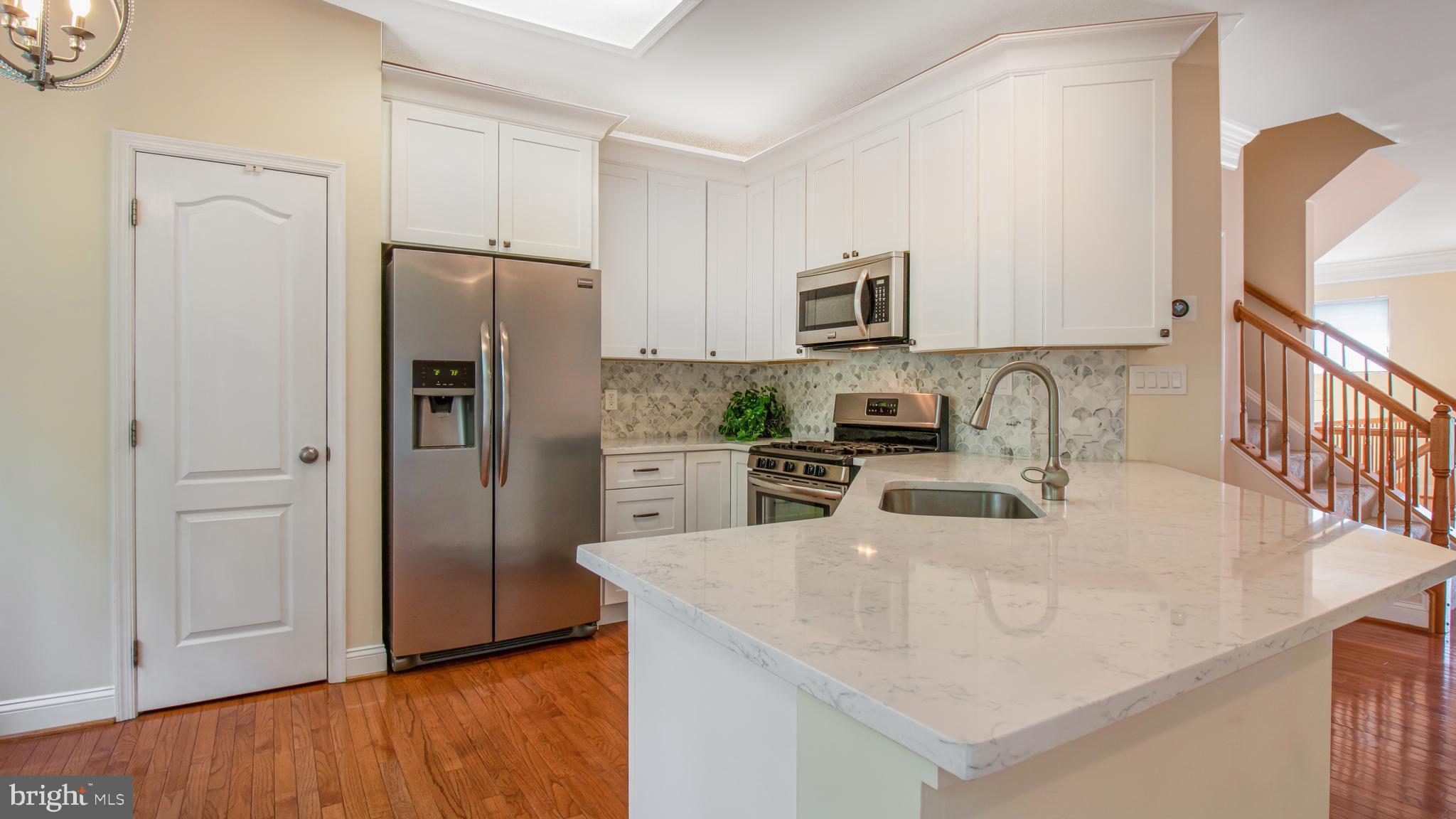 2080 Capstone Circle Herndon, VA 20170 - Photo 19 of 38 a kitchen with stainless steel appliances granite countertop a refrigerator a sink a stove a microwave and island