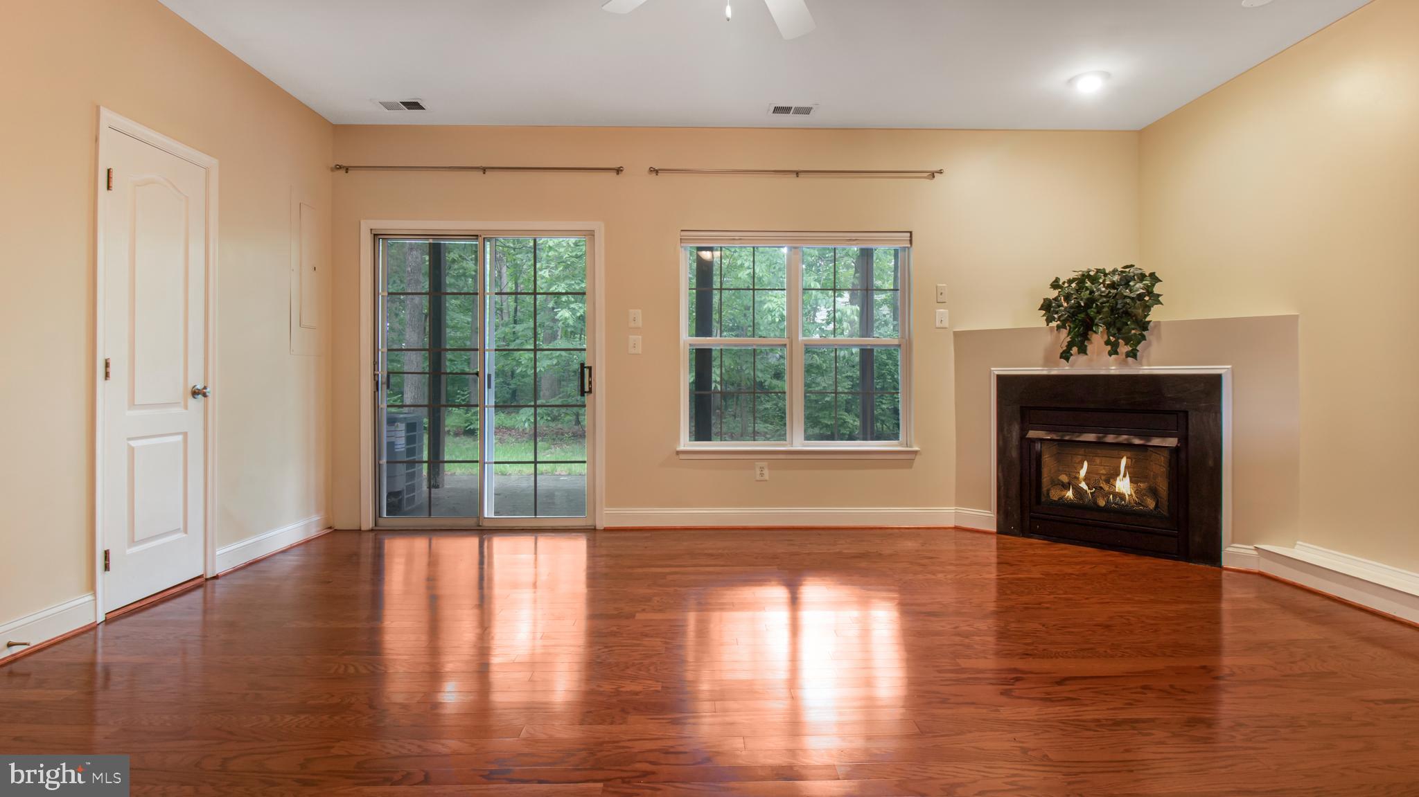 2080 Capstone Circle Herndon, VA 20170 - Photo 6 of 38 a view of an empty room with a window and wooden floor