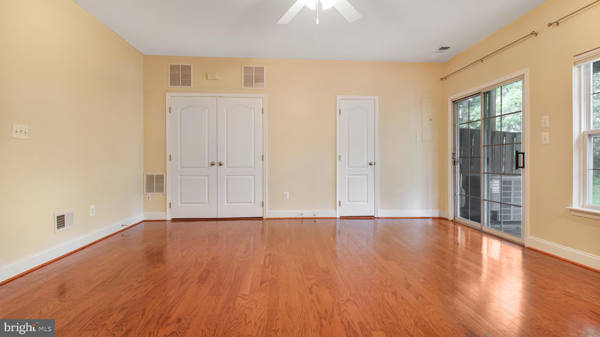 2080 Capstone Circle Herndon, VA 20170 - Photo 8 of 38 a view of an empty room with wooden floor and a window