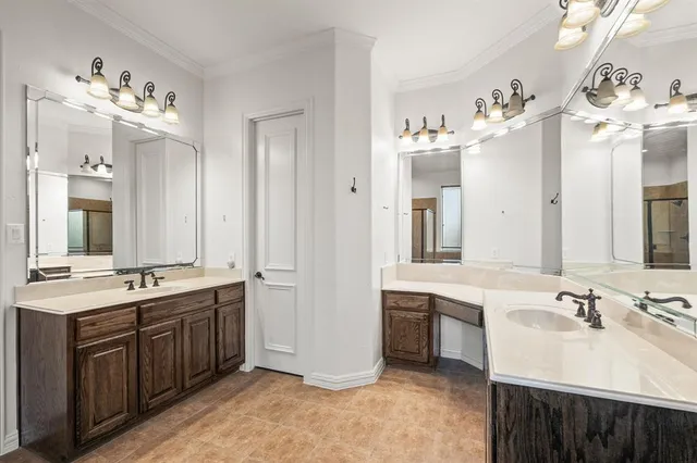 a bathroom with a double vanity sink mirror and
