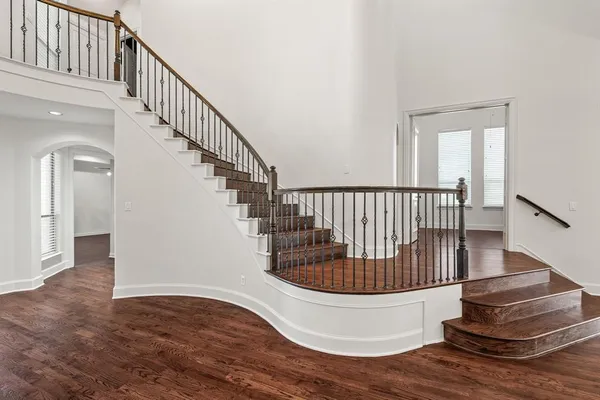 a view of entryway and hall with wooden floor