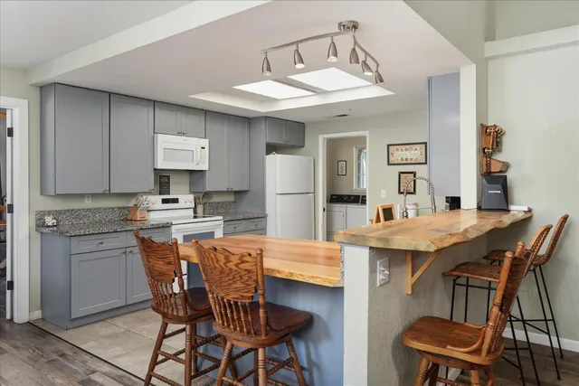 a large kitchen with a table and chairs