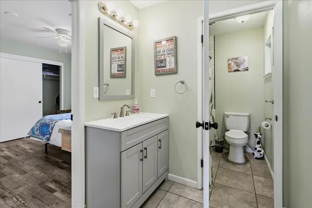 a white toilet sitting next to a bath tub