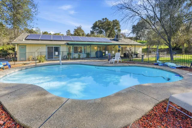 a patio with glass top table and chairs