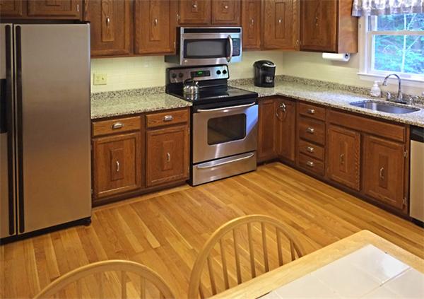 53 Squire Road Winchester, MA 01890 - Photo 3 of 11 a kitchen with stainless steel appliances granite countertop a stove a sink and a microwave