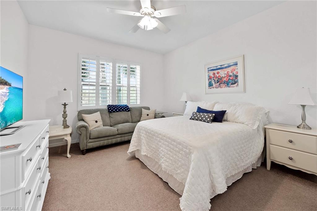 4685 Hawks Nest Way, Unit 103 Naples, FL 34114 - Photo 15 of 35 a bedroom with a bed and a couch