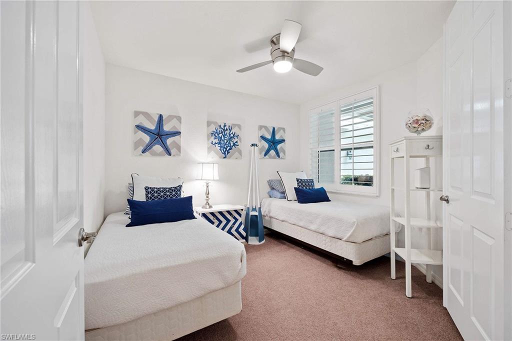 4685 Hawks Nest Way, Unit 103 Naples, FL 34114 - Photo 19 of 35 a spacious bedroom with two beds and painting on the wall