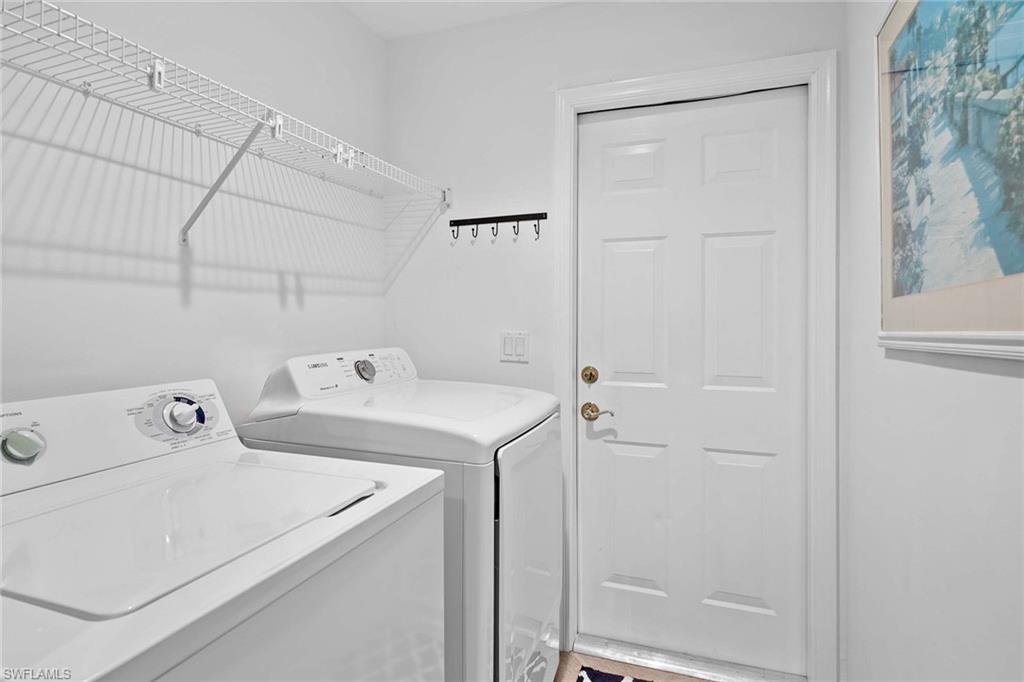 4685 Hawks Nest Way, Unit 103 Naples, FL 34114 - Photo 22 of 35 a utility room with dryer and washer
