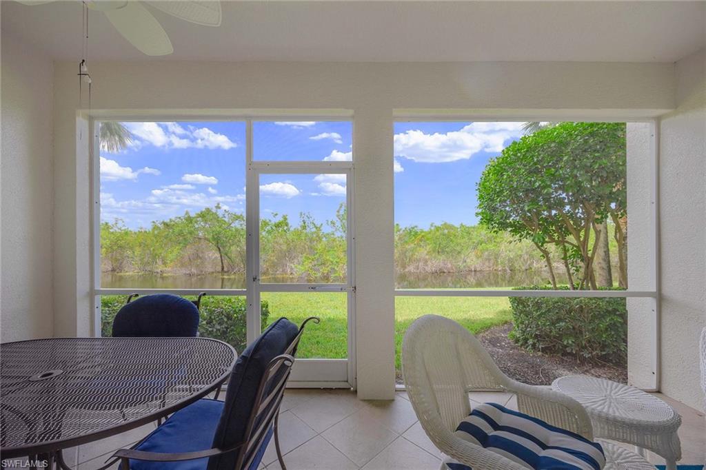 4685 Hawks Nest Way, Unit 103 Naples, FL 34114 - Photo 23 of 35 a view of a porch with furniture and a garden