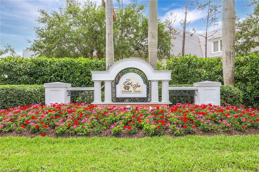 4685 Hawks Nest Way, Unit 103 Naples, FL 34114 - Photo 35 of 35 a front view of a house with a yard and fountain