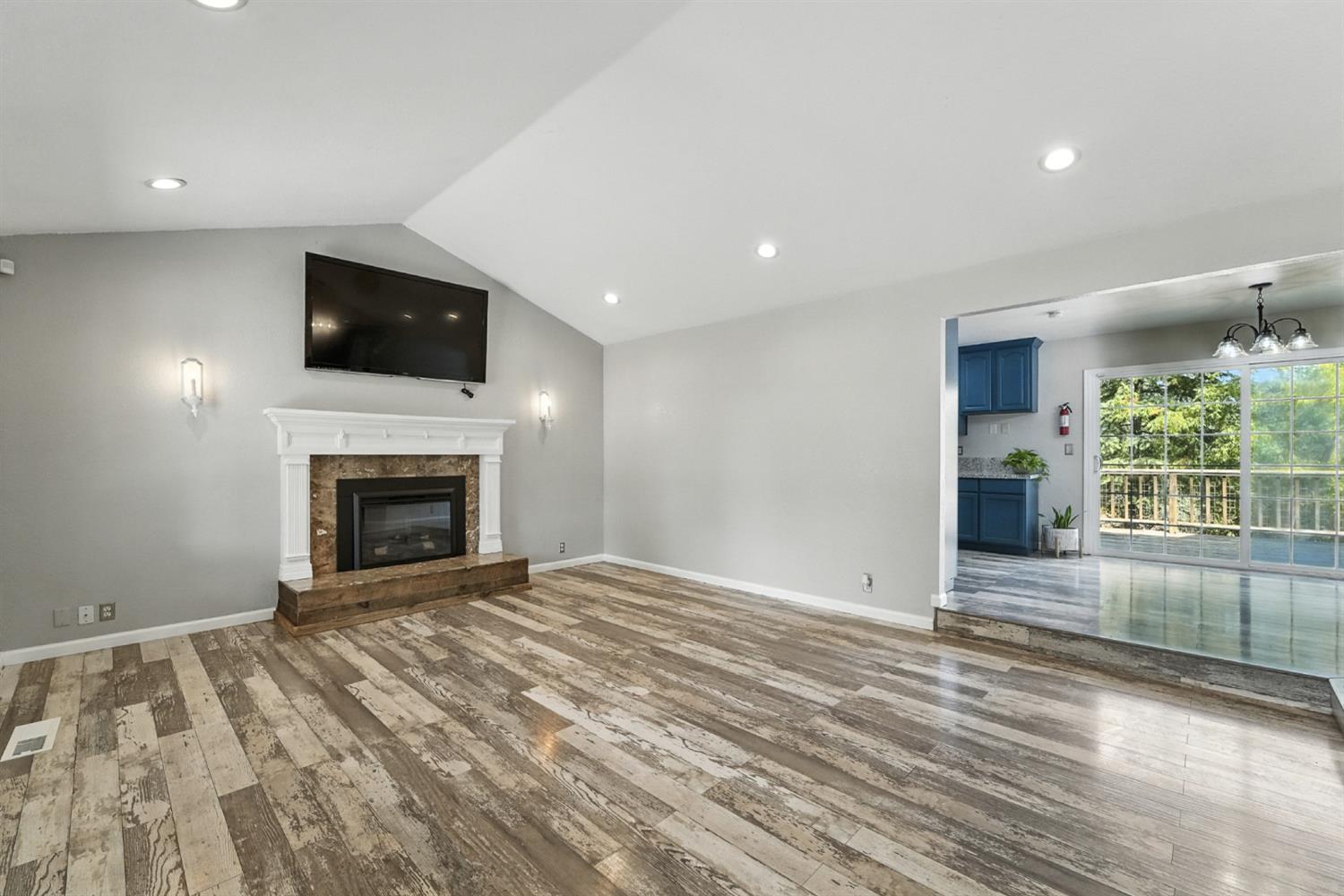 2422 Cheyenne Road Copperopolis, CA 95228 - Photo 11 of 64 a view of empty room with wooden floor and fireplace