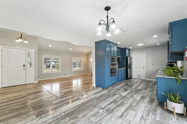 a kitchen with stainless steel appliances granite countertop a refrigerator and a stove