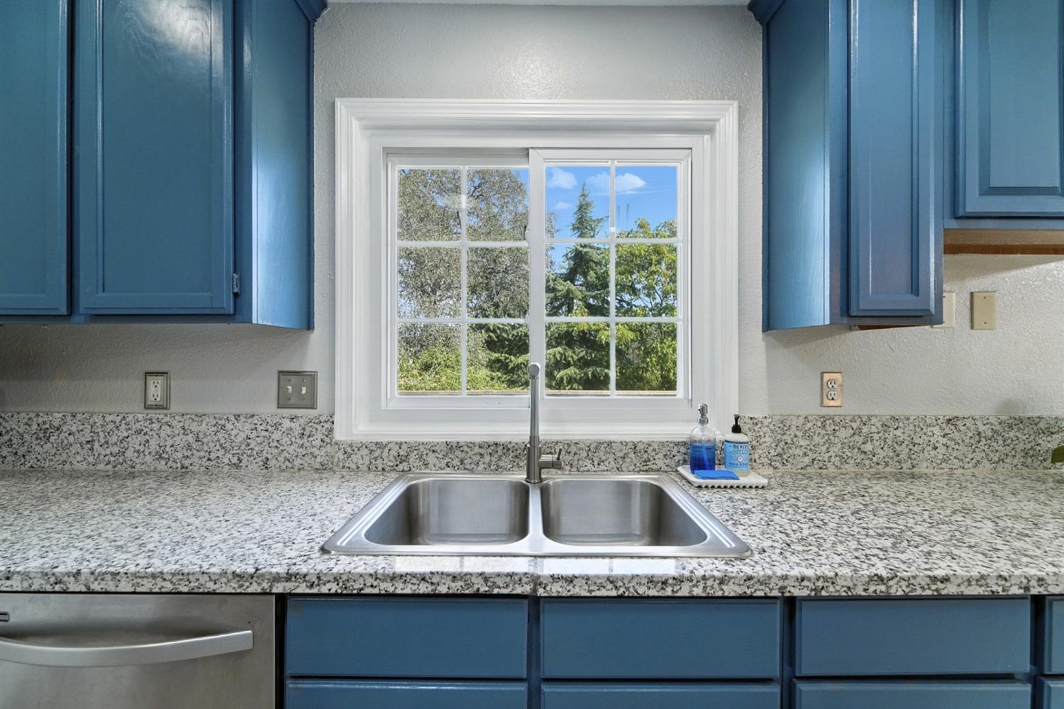 2422 Cheyenne Road Copperopolis, CA 95228 - Photo 17 of 64 a kitchen with granite countertop a sink window and cabinets