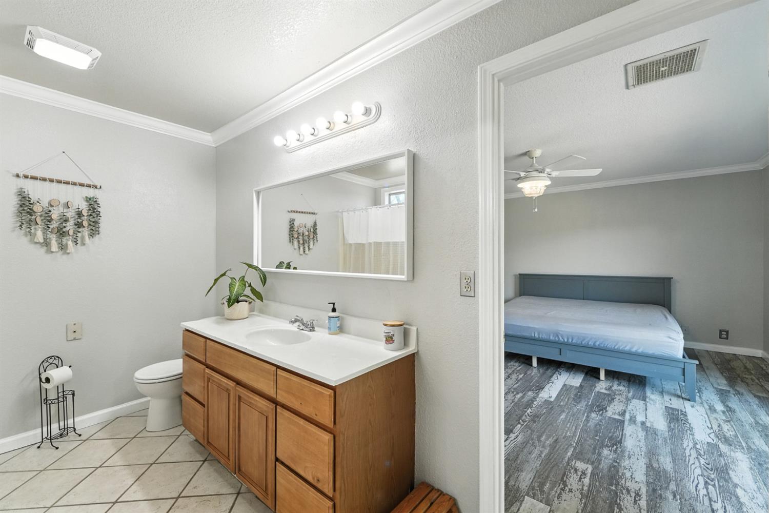 2422 Cheyenne Road Copperopolis, CA 95228 - Photo 27 of 64 a en suite bathroom with a toilet sink and mirror