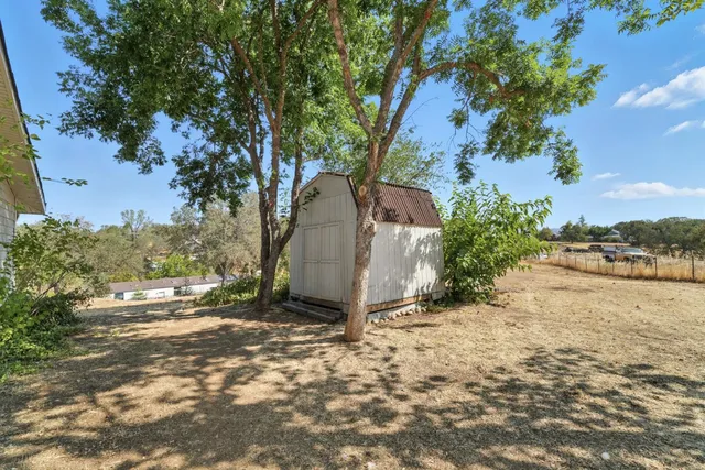 an aerial view of a house with a swimming pool yard and outdoor seating