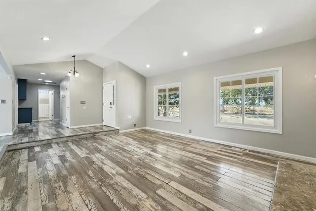 a living room with a fireplace and a flat screen tv