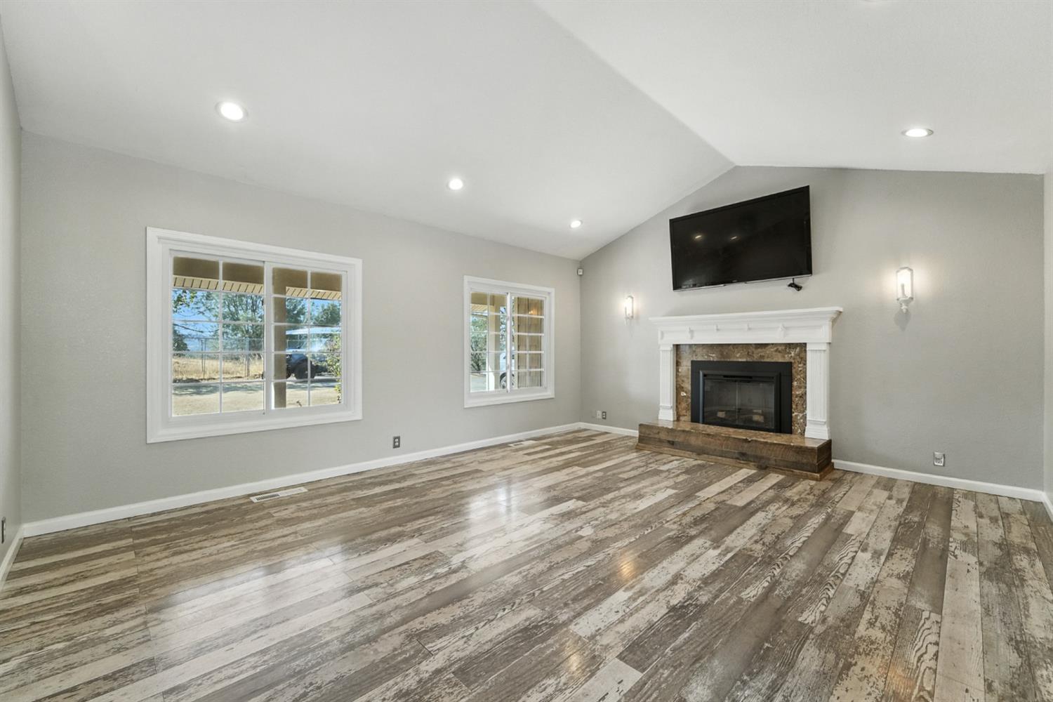 2422 Cheyenne Road Copperopolis, CA 95228 - Photo 8 of 64 a view of empty room with fireplace and wooden floor