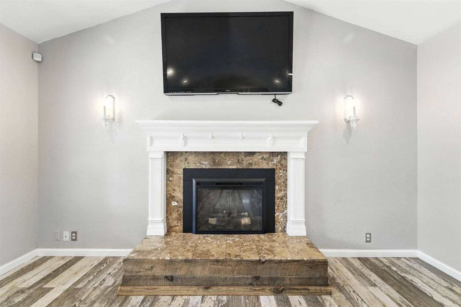 2422 Cheyenne Road Copperopolis, CA 95228 - Photo 9 of 64 a living room with a fireplace and a flat screen tv
