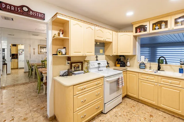 a kitchen with a sink stove and cabinets
