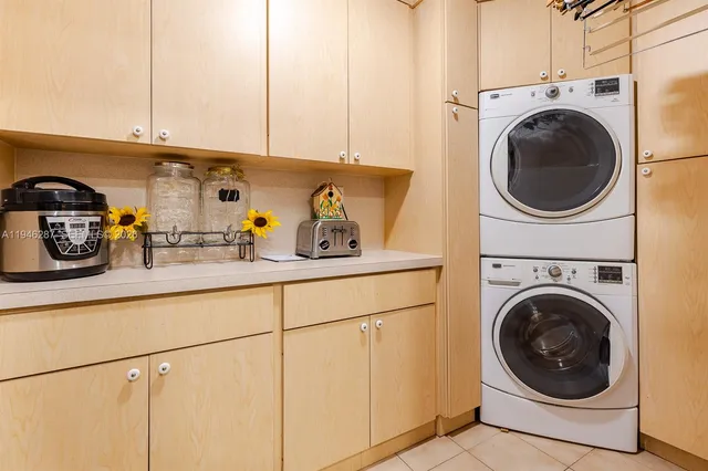 a utility room with sink dryer and washer