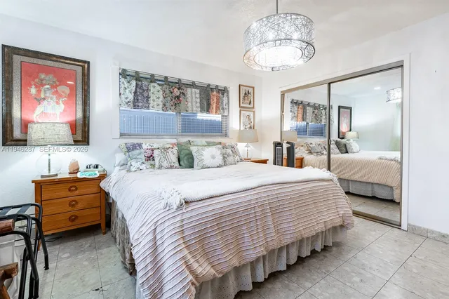 a bedroom with bed and window