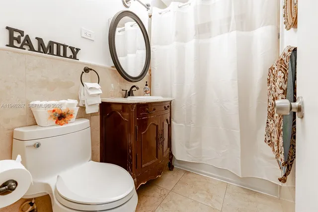 a white toilet sitting next to a bathroom sink