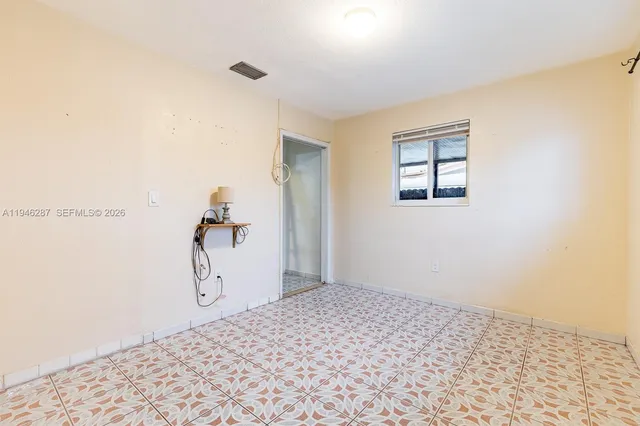 a bedroom with a bed and a wall painting