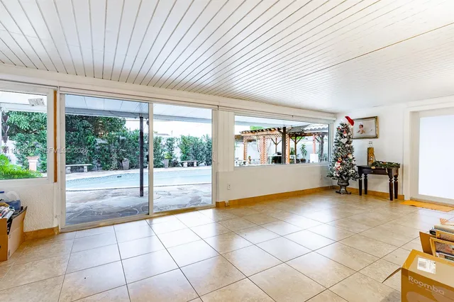 a view of a room with furniture and a large window