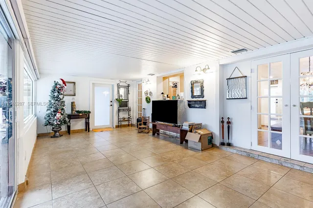 a view of a livingroom with workspace and a window